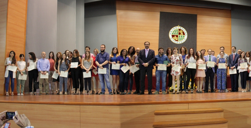 Foto de familia de alumnado de máster premiado, junto a representantes institucionales y profesorado.